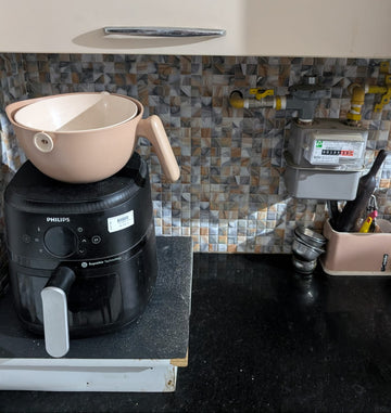 Kitchen counter with a Philips kitchen appliance and a tiled backsplash.