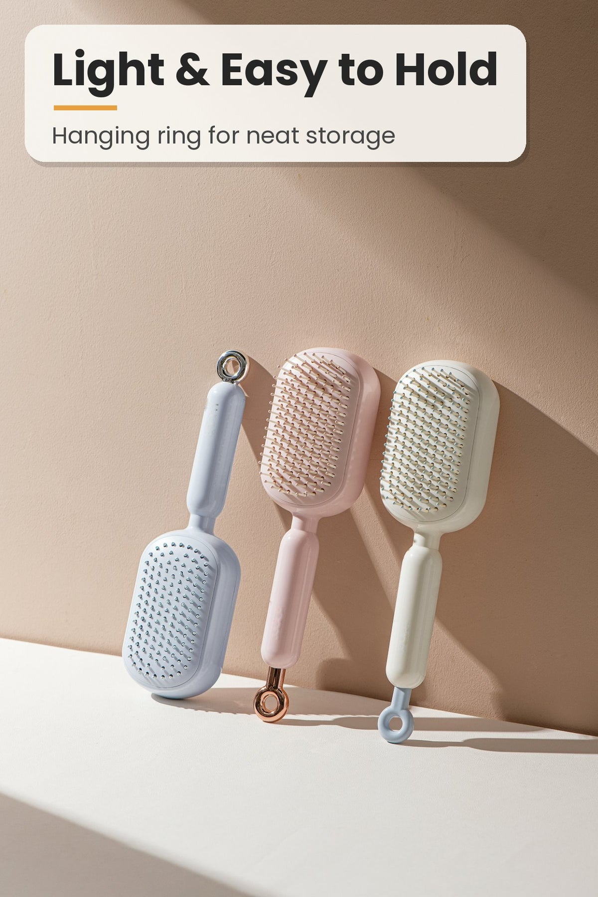 Self-cleaning hair brushes with hanging ring