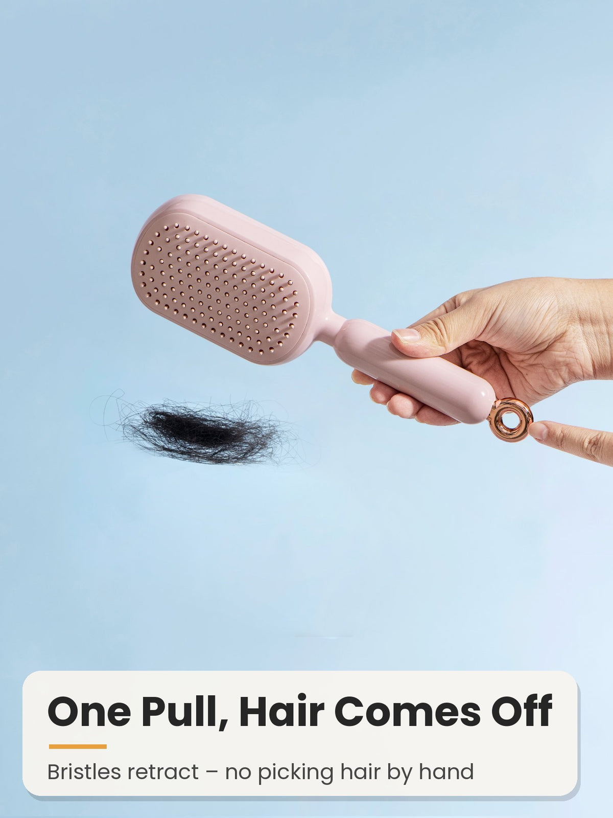 Pull the ring to retract bristles and remove hair from the brush